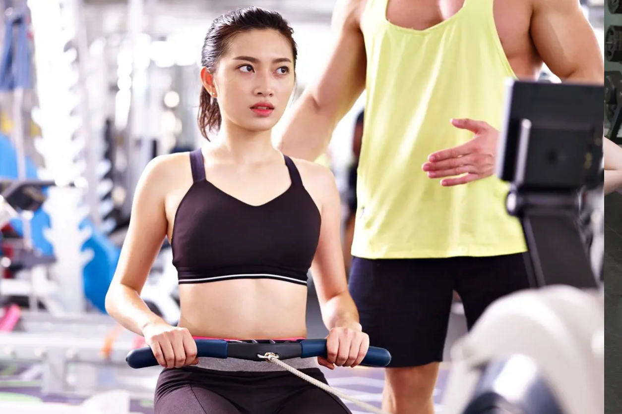 A woman is sitting on the rowing machine